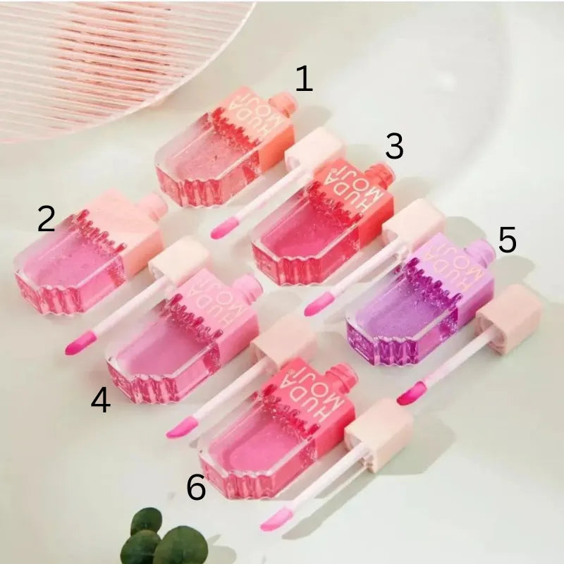 Hudamoji Transparent Lipgloss Oil in Light Pink Color Each Huda Moji